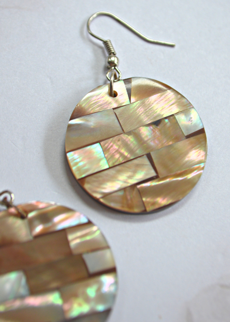 close up of light brown Mother of Pearl Disc Earrings laid on a white background