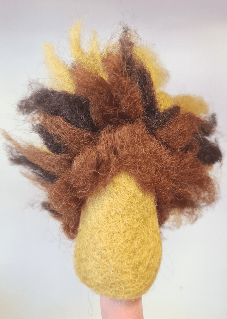 back of a wild yellow felt lion with a fuzzy brown mane sat on someone&