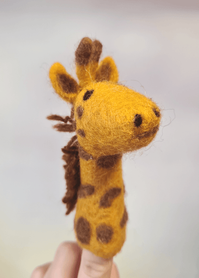 yellow felt giraffe finger puppet with brown spots and mane sat on someones finger