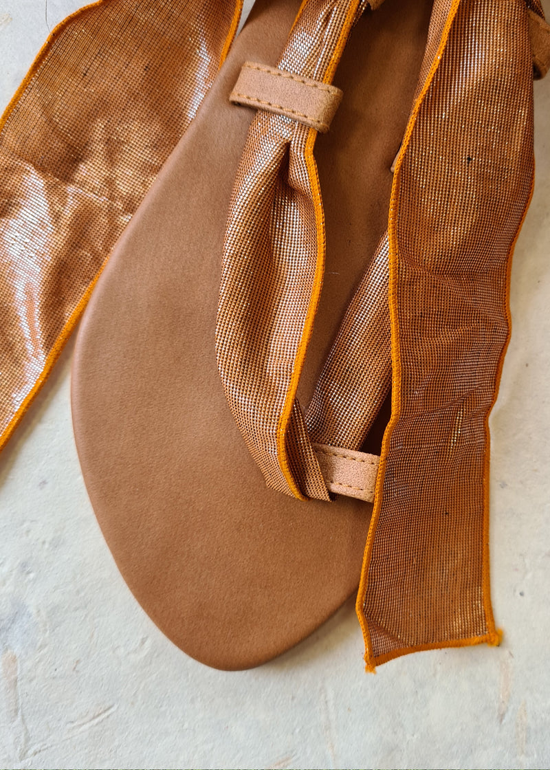 close up of brown metallic lace up sandal