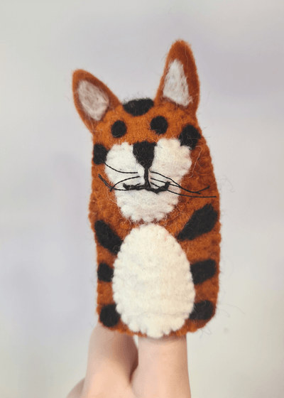 Elefair Giftware kids handmade ethical toy, orange and black felt tiger finger puppet with white belly, ears and face sat on someones finger, handmade in nepal