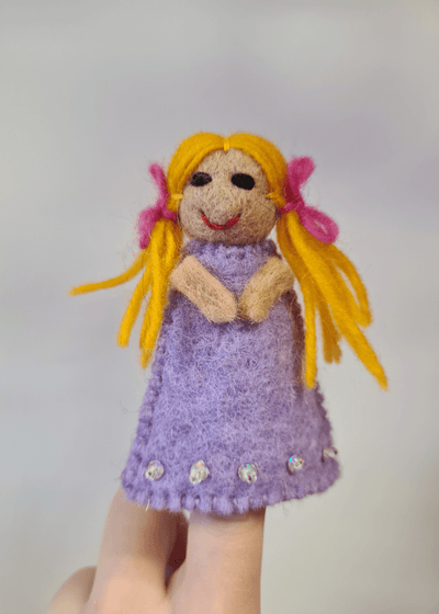 Little girl felt finger puppet wearing lilac dress with blond pigtails and pink bows on someones finger