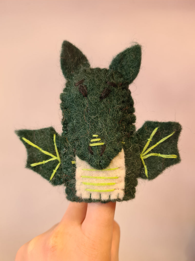 Elefair Giftware green felt dragon finger puppet with white chest and yellow thread in wings sitting on a finger