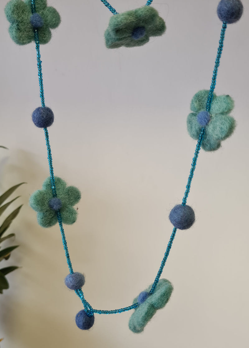 Blue pom pom flower necklace with beads hanging