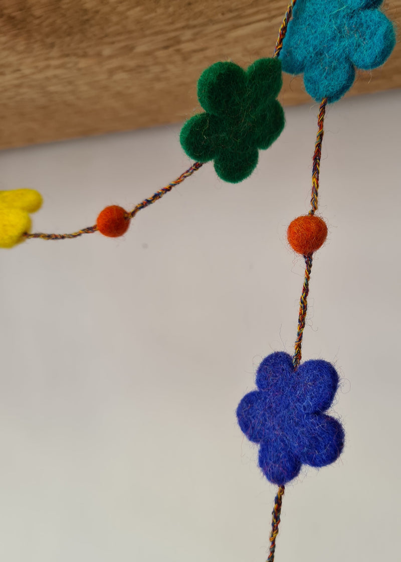 close up of flowers on multi-colour felt pom pom flower necklace