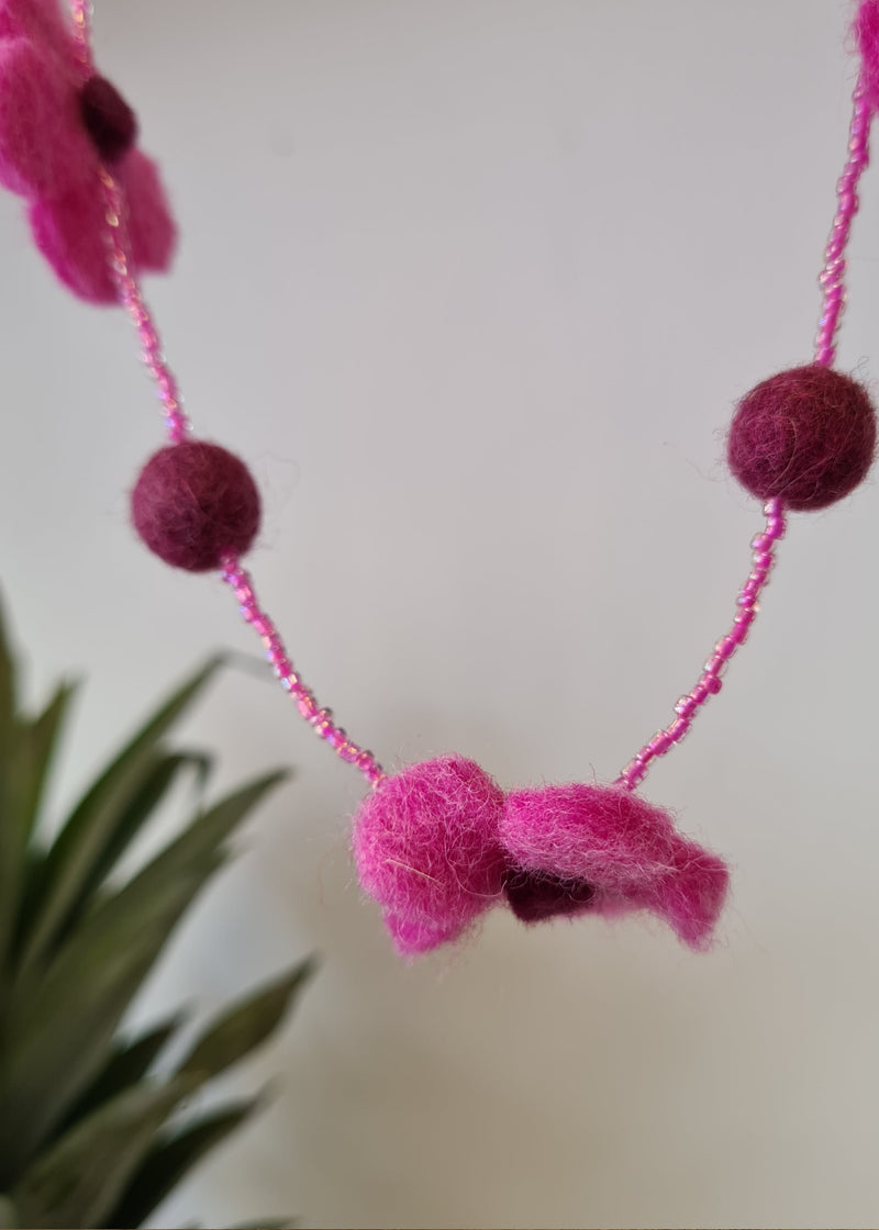 Pink pom pom flower necklace with beads hanging